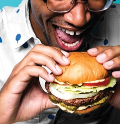 Man eating Impossible Burger. Photo courtesy of Impossible Foods 