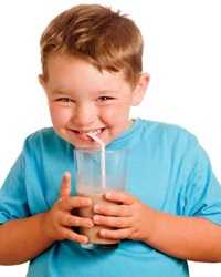 boy drinking chocolate beverage