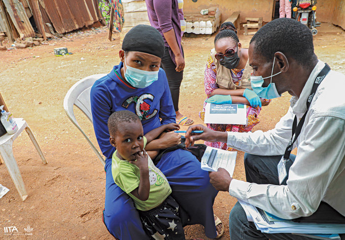 Mercy Lung’aho (center right), spot checks a field interviewer in Ibadan, Nigeria,