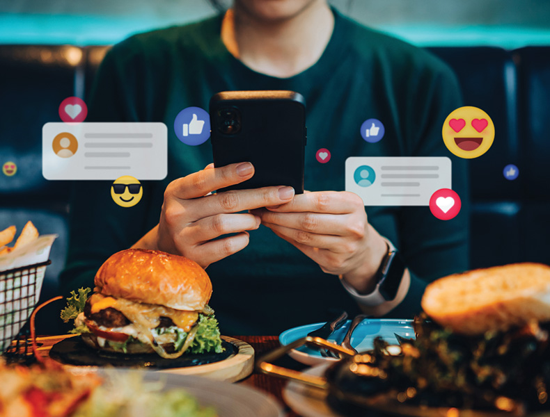 Woman using smartphone on social media app during meal in restaurant.