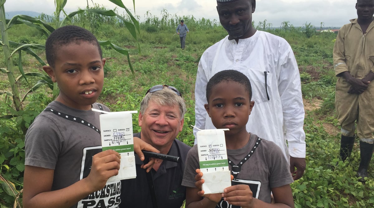 Robert Saik (center) teaches young Nigerians about soil sampling and crop nutrition.