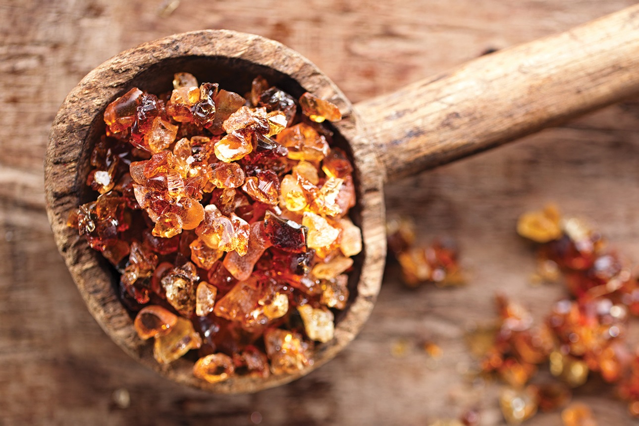 Gum arabic, also known as acacia gum - in old wooden spoon