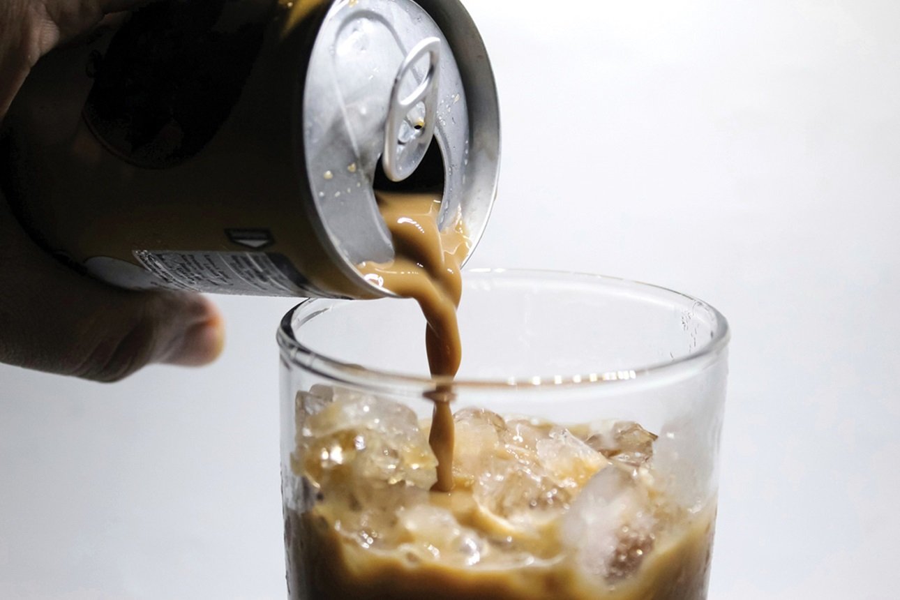 Pouring canned coffee into a glass