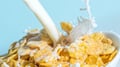 Milk stream pouring into a bowl with сornflakes