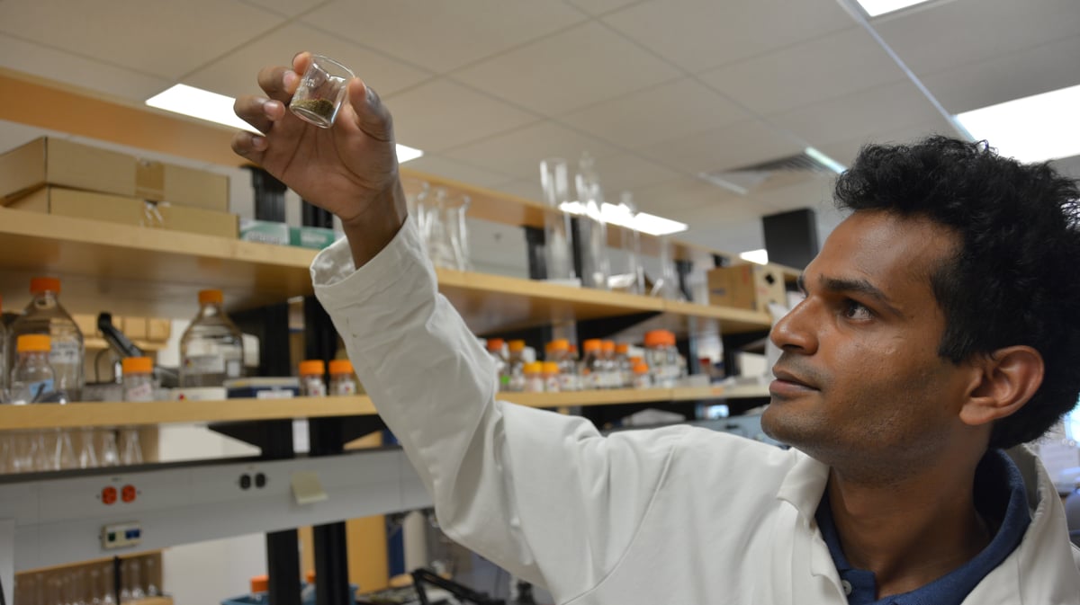 Man holding Jar in Lab