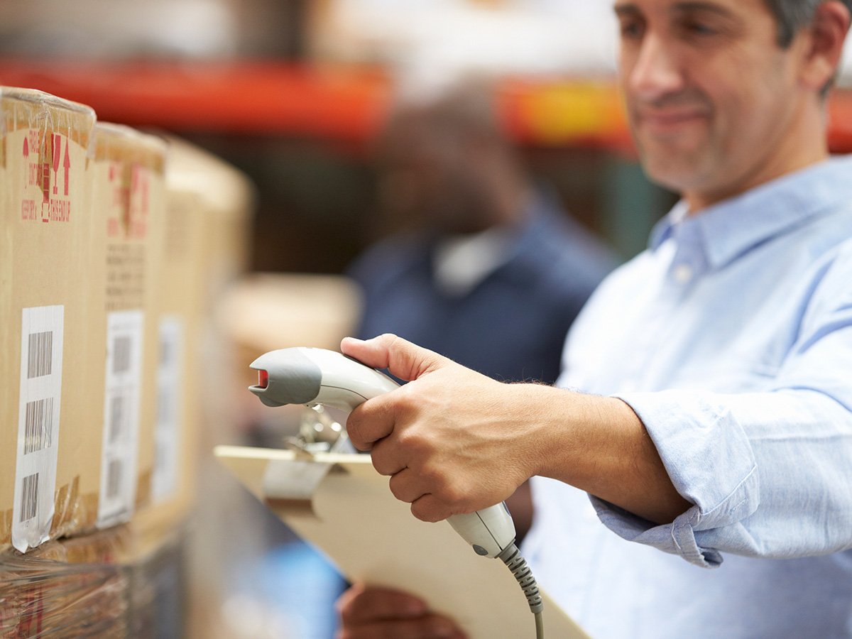 Man scanning a barcode on a box.