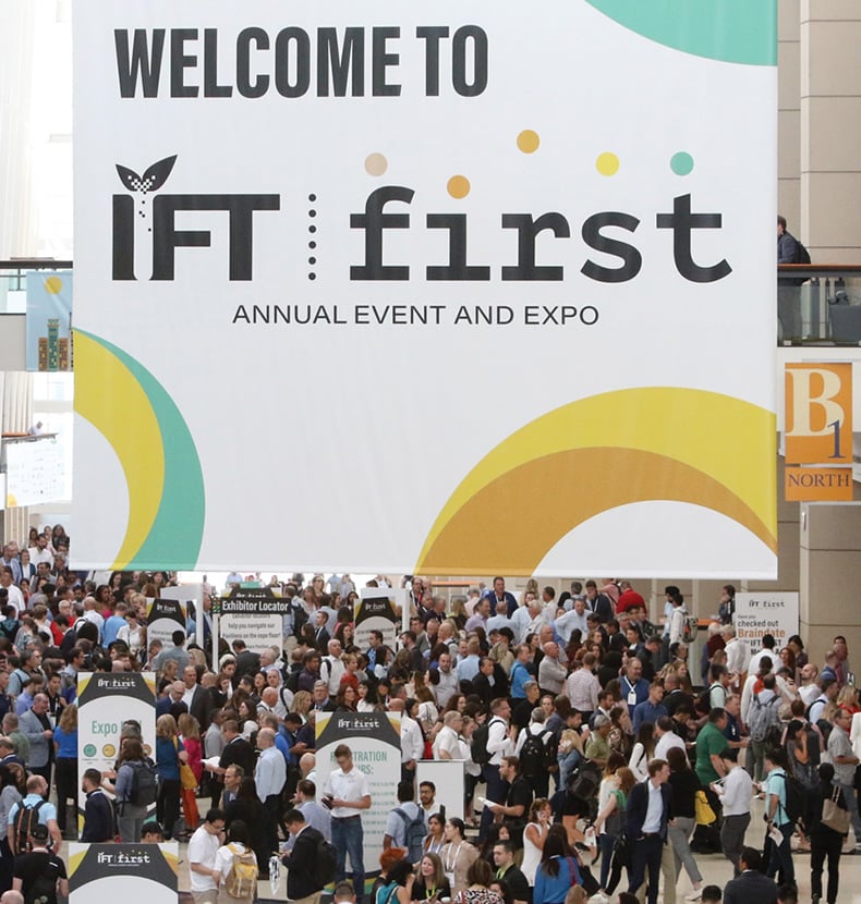 Welcome to IFT FIRST banner above a bustling crowd of attendees
