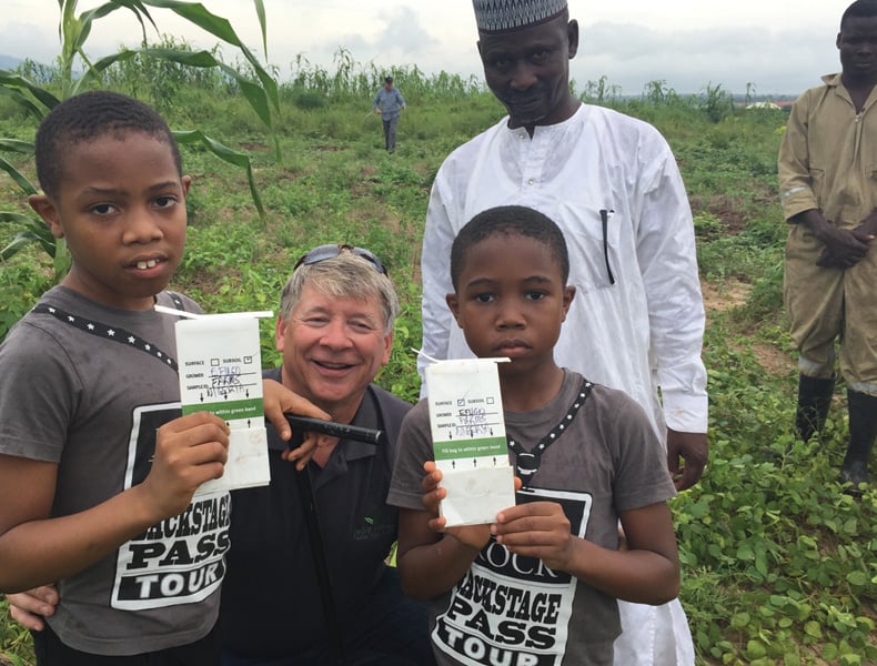 Robert Saik (center) teaches young Nigerians about soil sampling and crop nutrition.