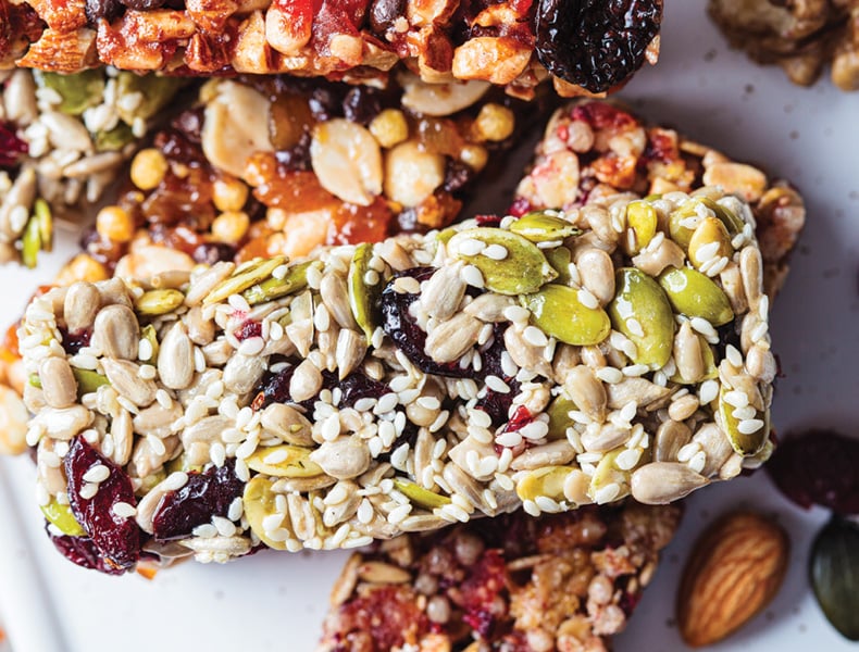 Energy granola bars with different seeds, nuts and dried fruits and berries