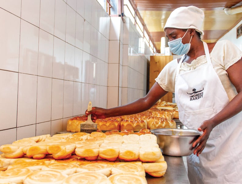 A baker prepares buns.