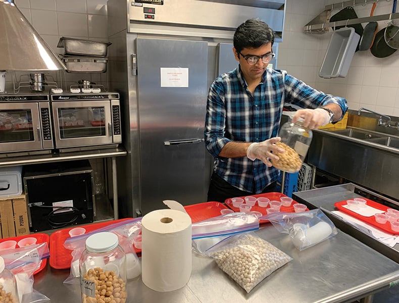 Aamir Iqbal, a postdoctoral food science researcher at Cornell University, prepares to share a puff product with taste testers.