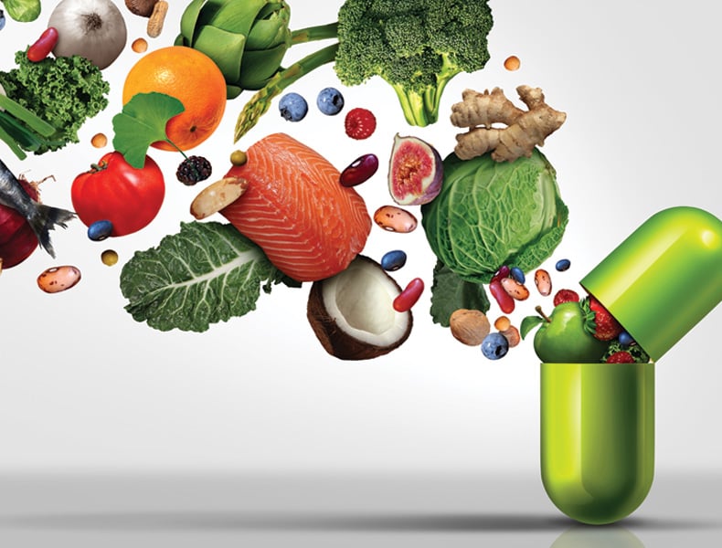 Medicine capsule with fruit vegetables nuts and beans inside as a natural medicine health treatment.