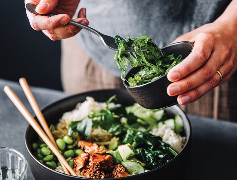 Close-up of woman eating omega 3 rich salad.