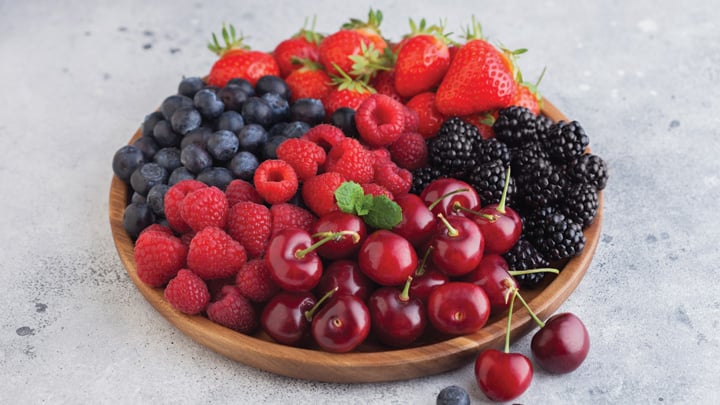 Summer berries in a wooden bowl.