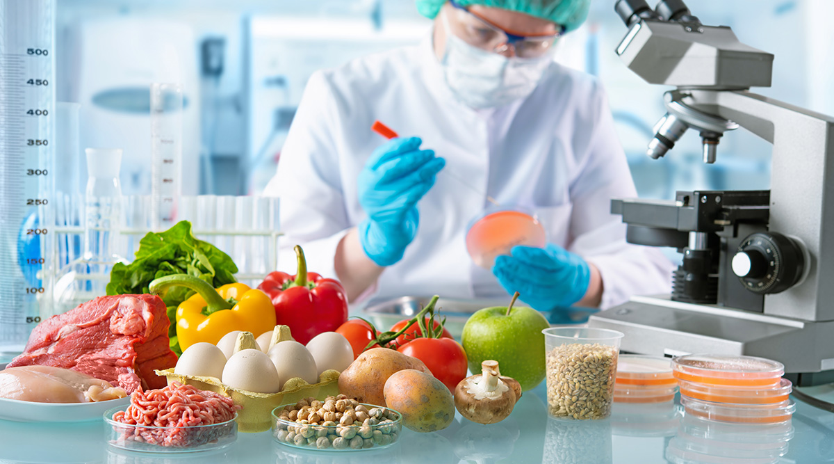 A food scientist uses a microscope to study the contents of meat, fruits, and vegetables
