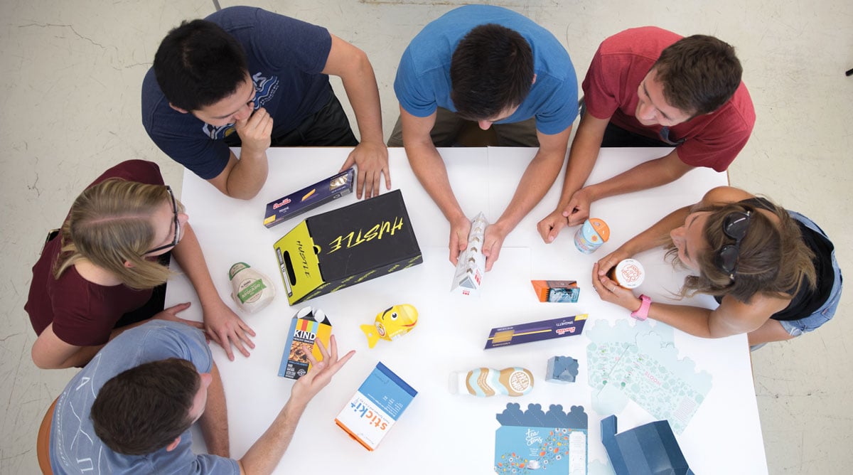 Six people sitting around a table