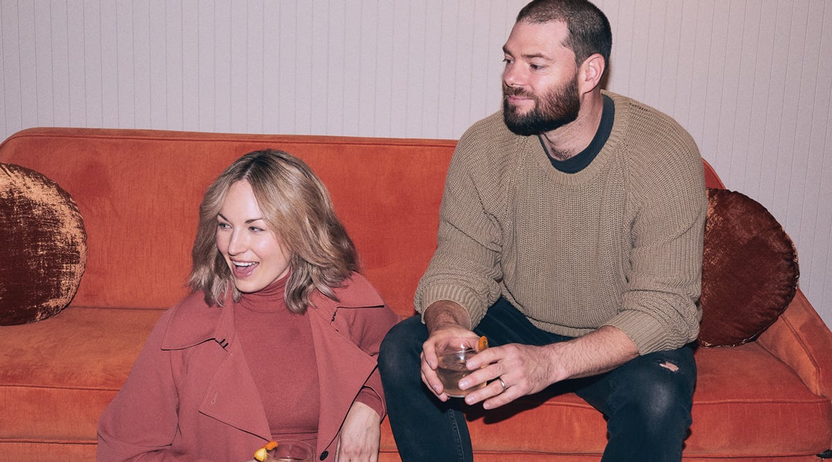 Adult and Child sitting on red couch