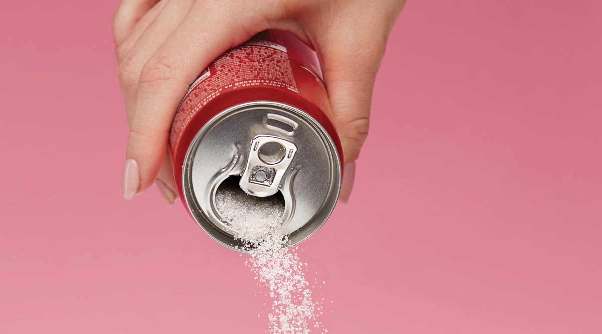 Sweetener pouring from soda can.