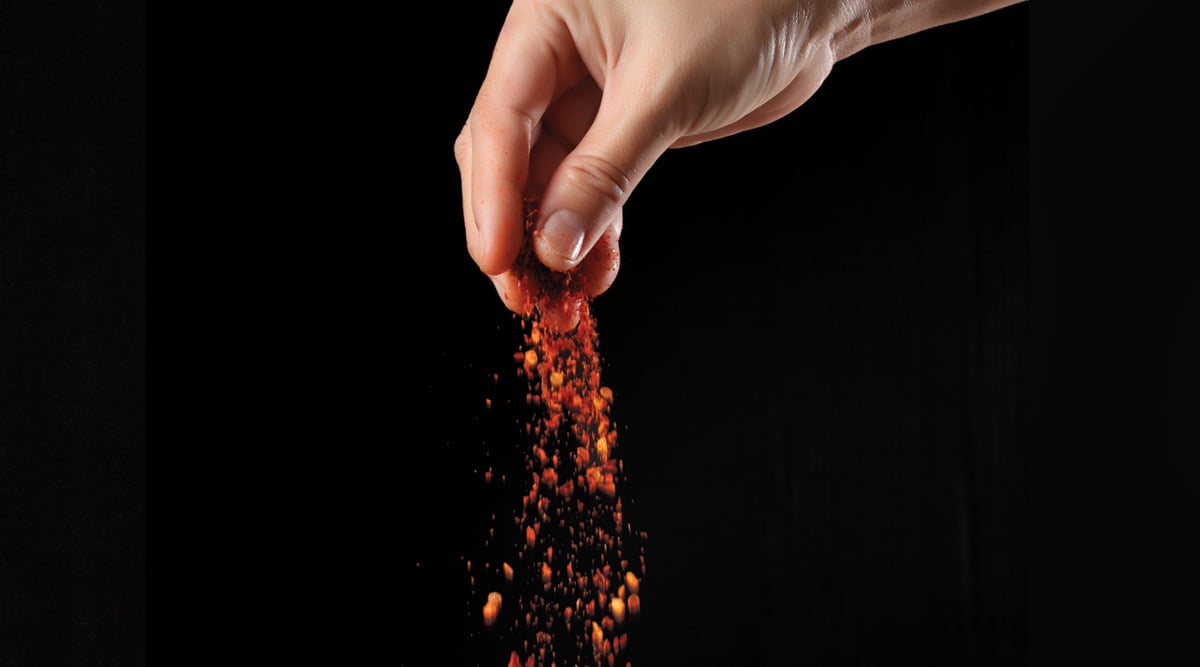 Hand sprinkling cayenne pepper
