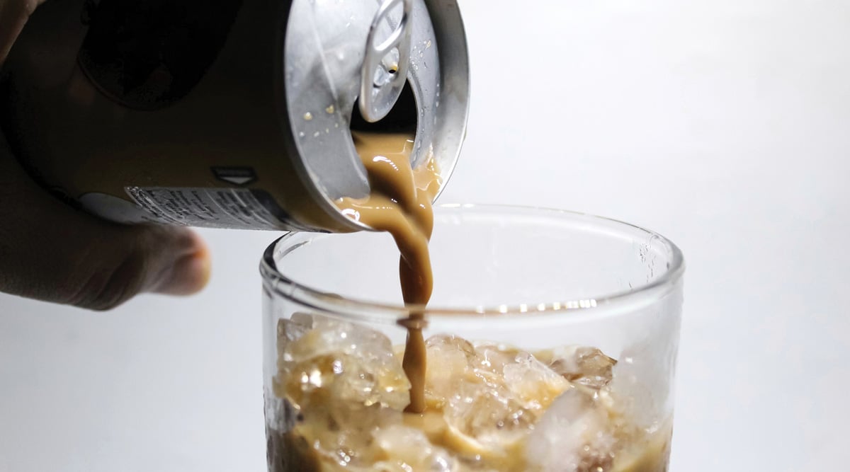 Pouring canned coffee into a glass