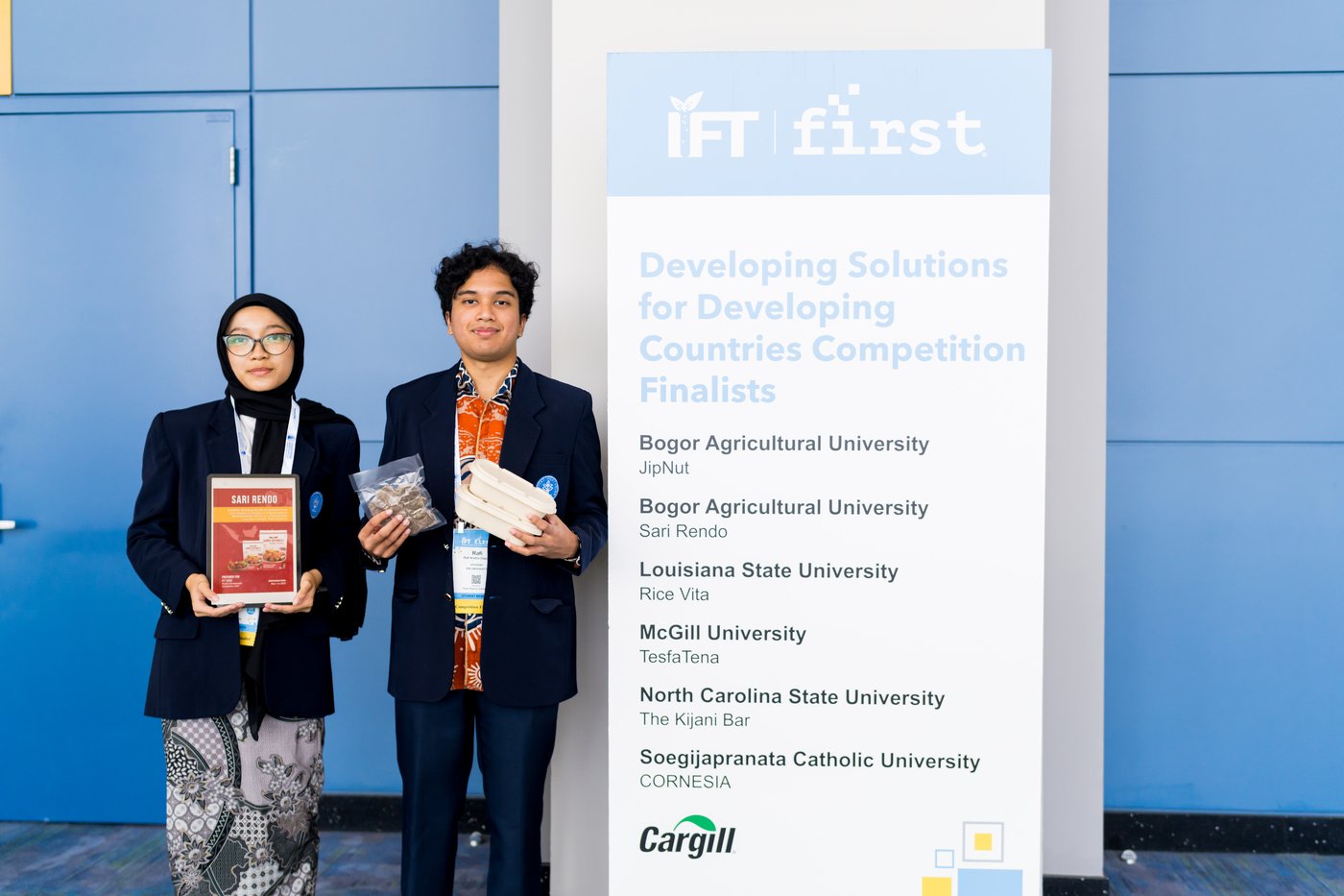 two student finalists with products