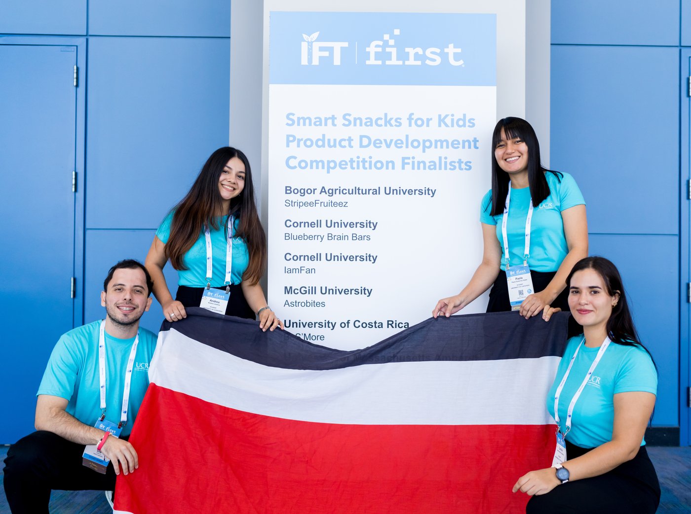 IFTSA global student competition finalists holding a flag at IFT FIRST.