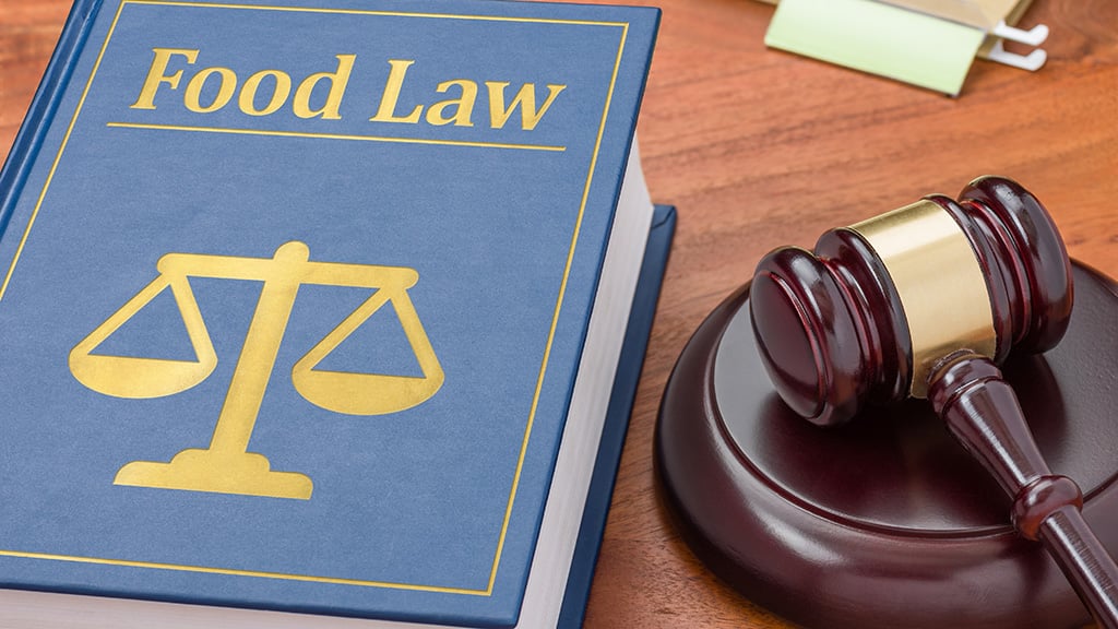 Food Law book and a gavel on a desk.