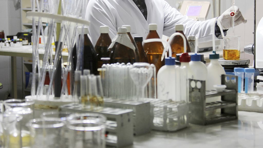 Scientist in a lab using a pipette.