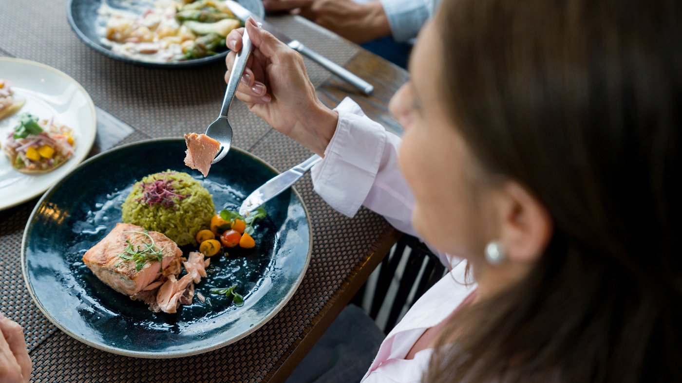 woman eating meal at restaurant
