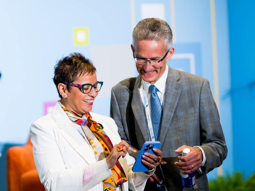 Two individuals Looking at Phone