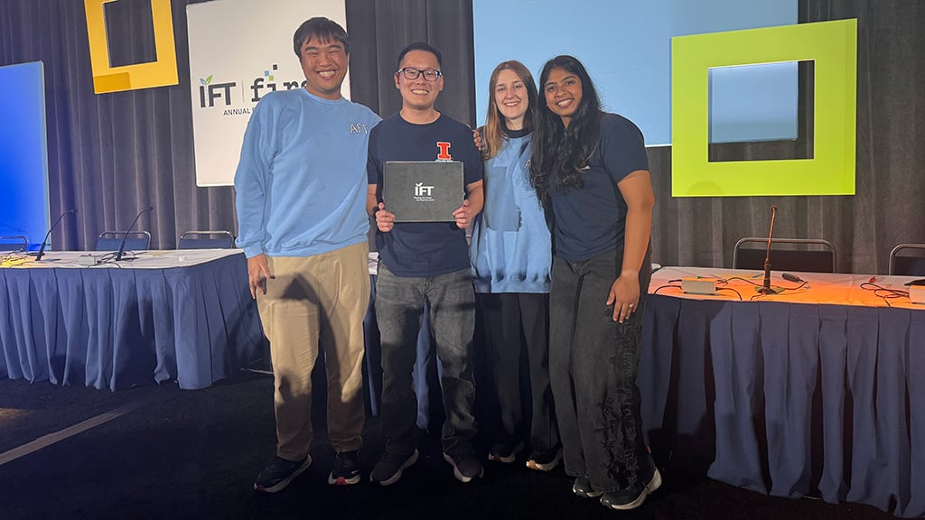 Four students from University of Illinois Urbana-Champaign standing on stage as winners of IFTSA College Bowl.