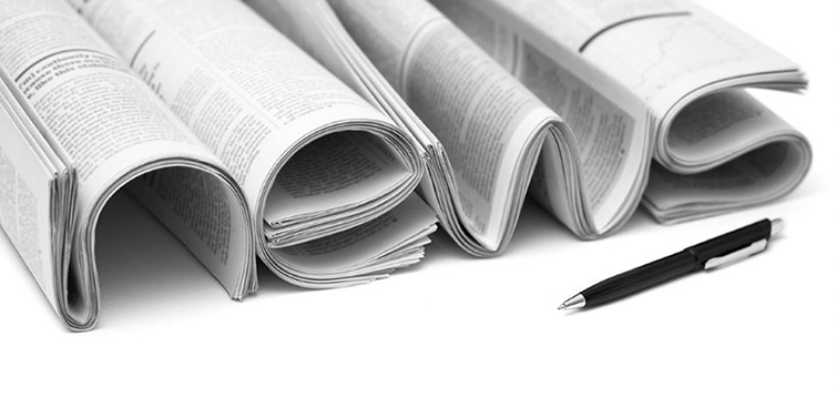 Newspaper in the shape of the word "news" and a pen.