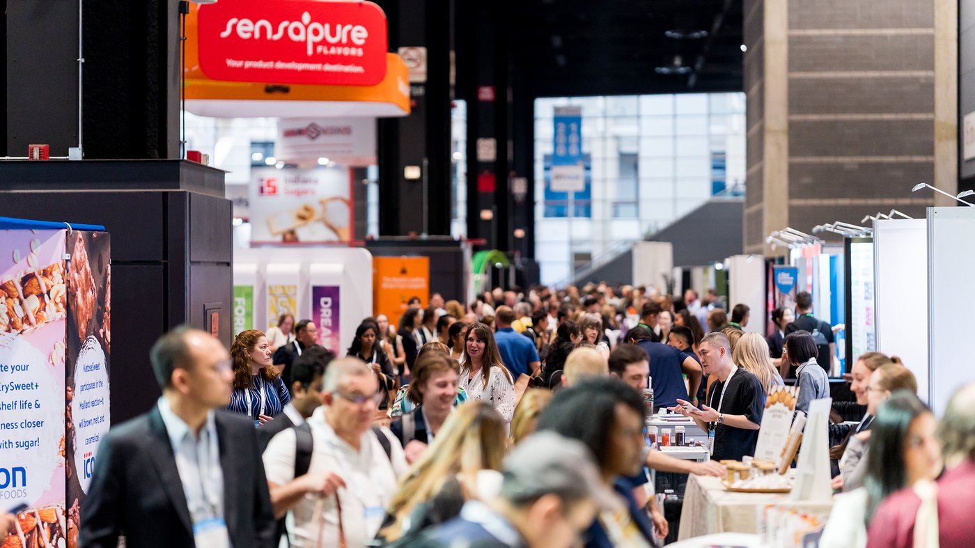 A busy expo hall of exhibitor booths and attendees at IFT FIRST in McCormick Place, Chicago, IL