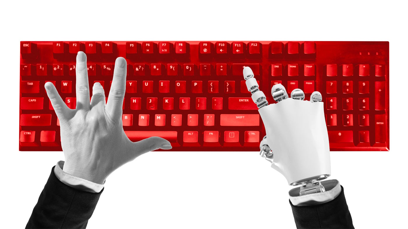 Composition of human and robotic hands typing on red keyboard symbolizing digital cooperation.