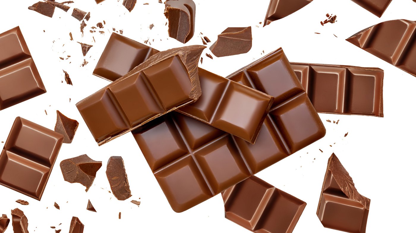 Milk Chocolate explosion with levitating cocoa crumbs Top view. Flat lay. Pattern