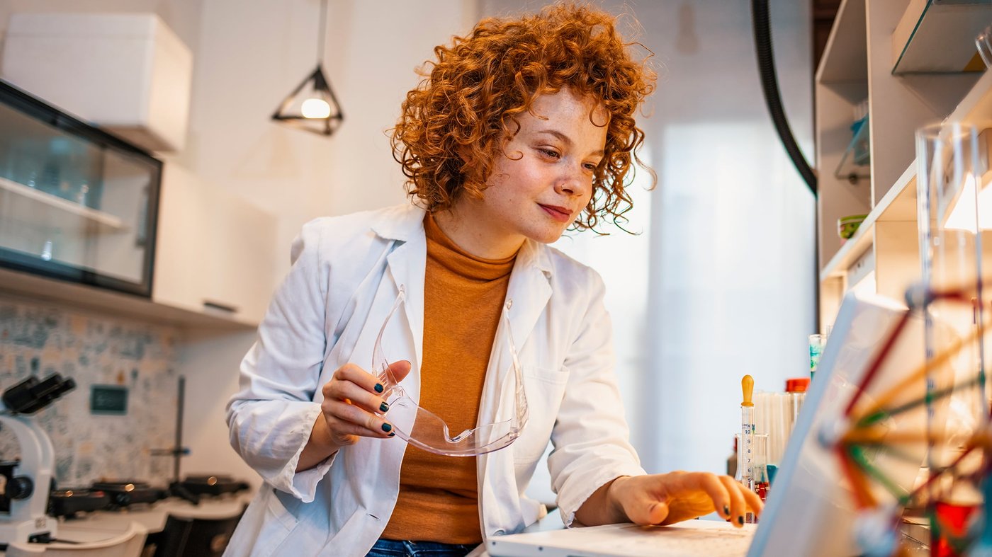 Female scientist working on computer in laboratory