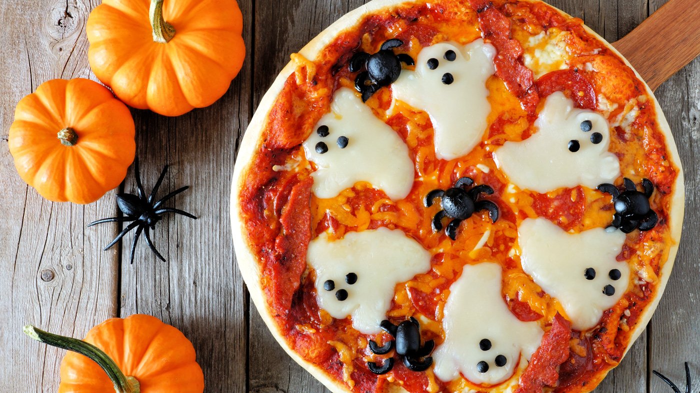 Halloween pizza with ghosts and spiders.