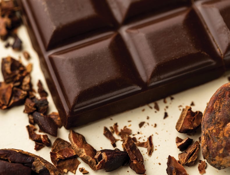 Gourmet and appetizing dark chocolate bar with cocoa beans.