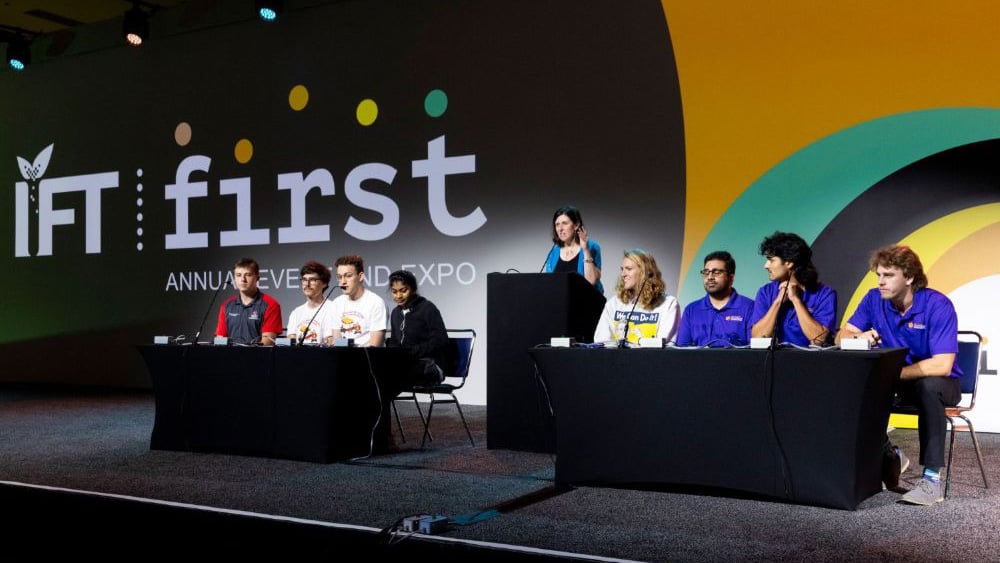 Students competing in the IFTSA College Bowl Competition on stage at IFT FIRST.