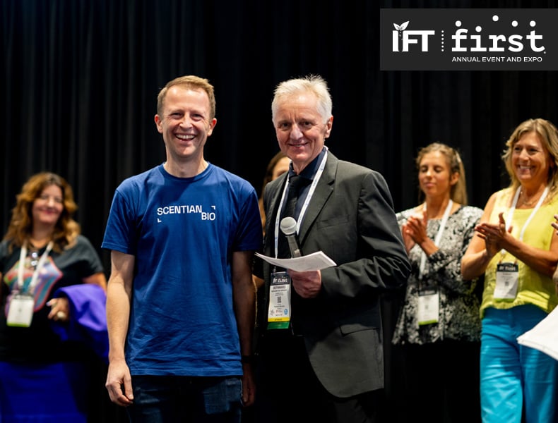 Scentian Bio CEO Jonathan Good (left) receives congratulations from Bernhard van Lengerich, founder of the Seeding The Future Foundation, after winning grand prize in the IFT FIRST Pitch competition