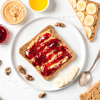 Homemade peanut butter sandwiches with raspberry jam and banana.