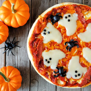 Halloween pizza with ghosts and spiders.