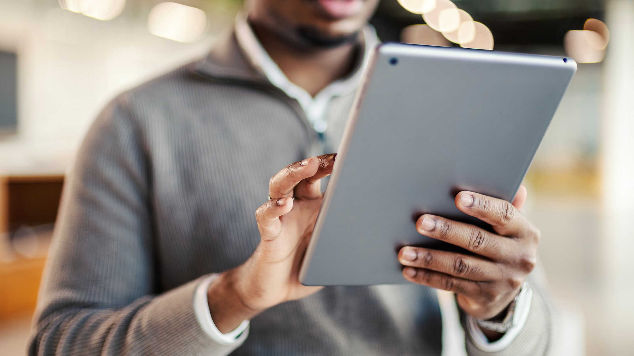 man reads on an tablet