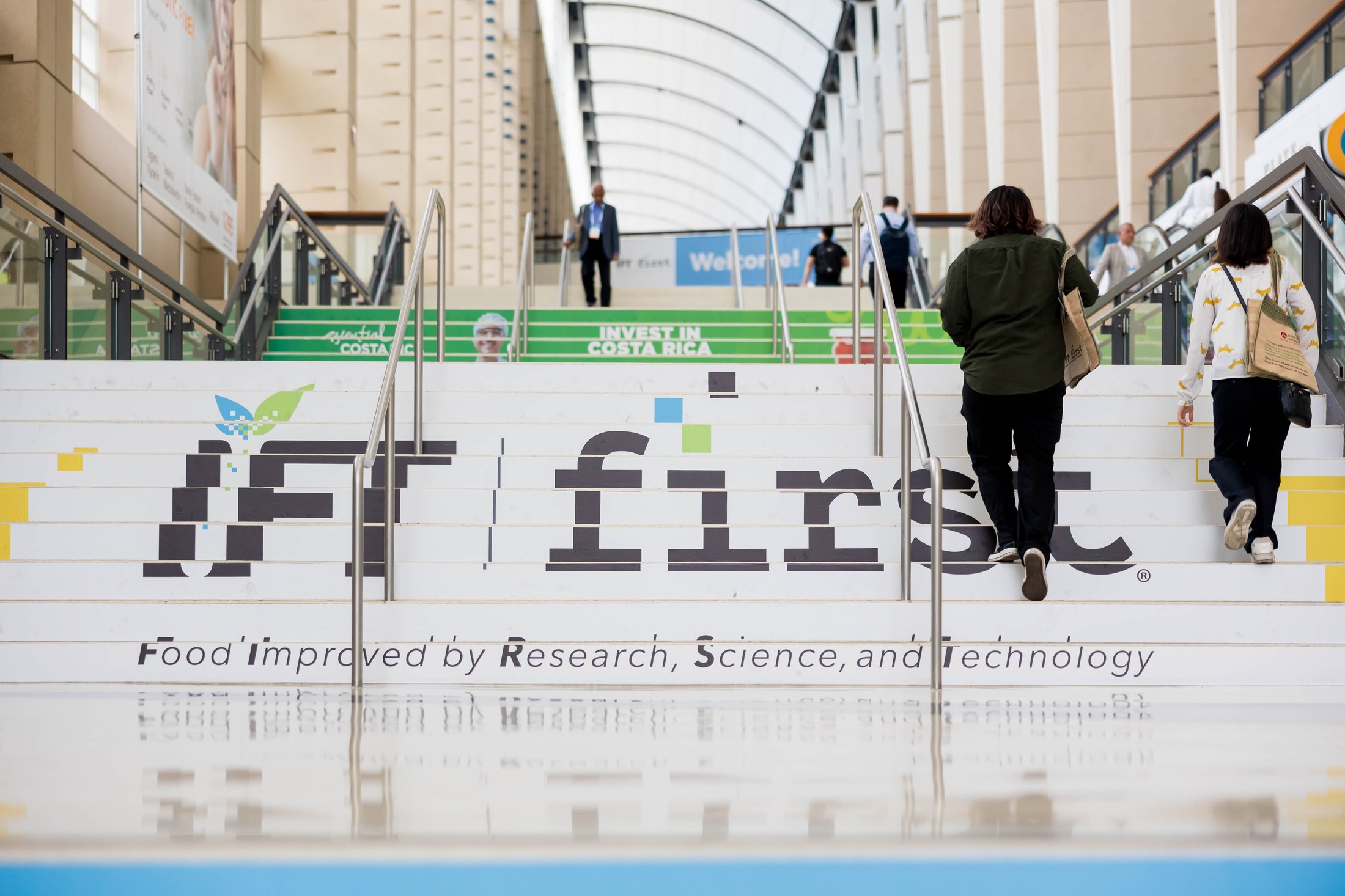Sponsor ad on the steps of McCormick Place at IFT FIRST as people walk up.