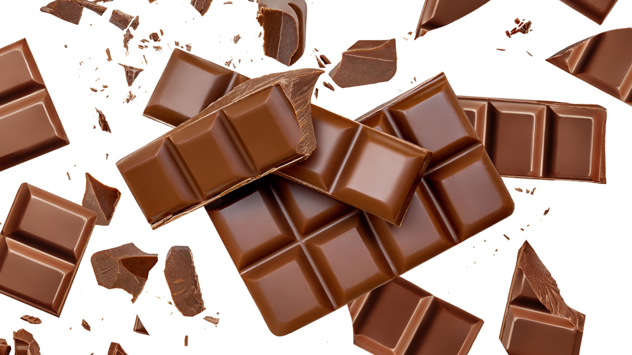 Milk Chocolate explosion with levitating cocoa crumbs Top view. Flat lay. Pattern