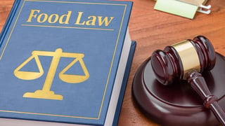 Food Law book and a gavel on a desk.