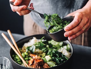 Close-up of woman eating omega 3 rich salad.