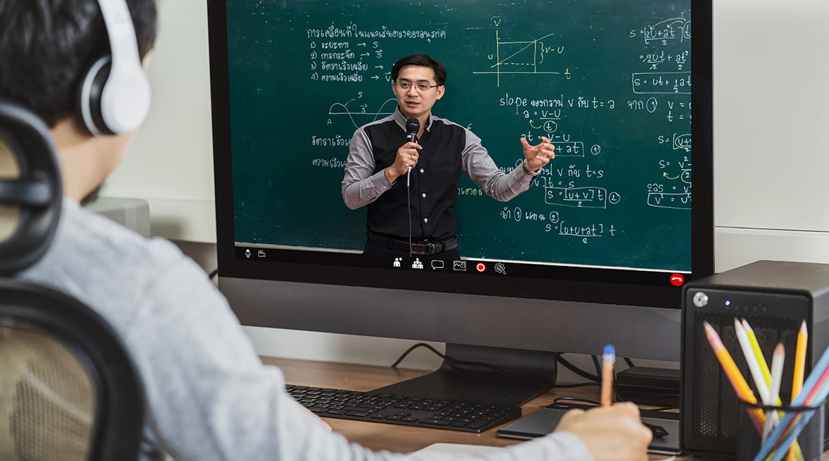 An instructor delivers an online lesson to a high school student.