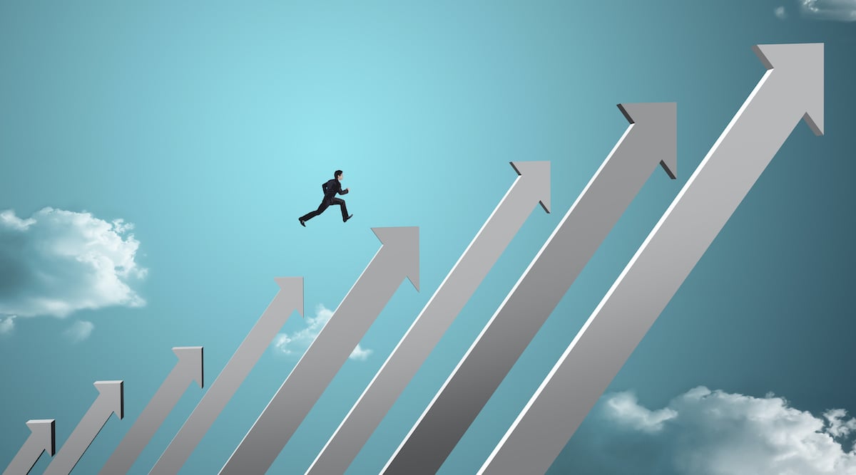 Man in suit climbing to the top