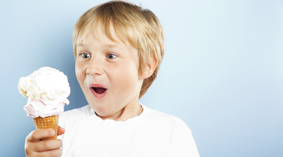 little boy eats ice cream cone